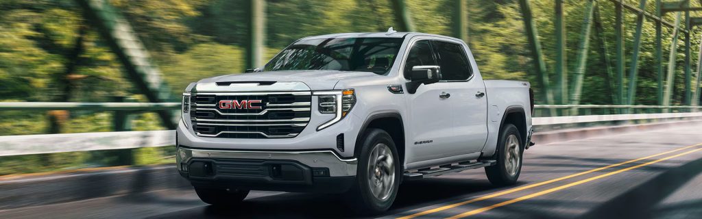 GMC Sierra truck driving on road