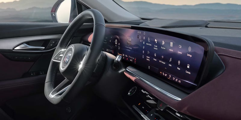 Luxury vehicle interior featuring a digital dashboard display, steering wheel, and modern infotainment controls.