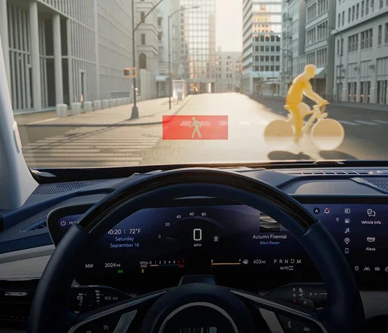 Buick driver view showing pedestrian and bicyclist detection alerts ahead