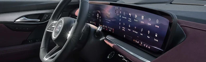 Envision cabin showing the steering wheel and the wide curved touchscreen displaying its app menu