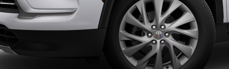 Close-up of a Buick Enclave front wheel with a multi-spoke alloy rim and Buick center cap