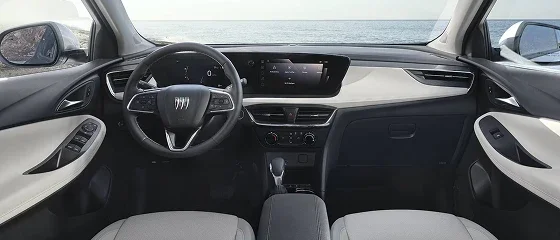 Interior of the 2026 Buick Encore GX Preferred with light cream upholstery, the steering wheel and the 11-inch touchscreen