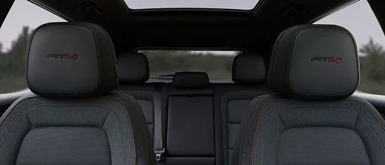 Interior of the 2027 GMC Terrain Elevation looking rearward over the front headrests to the second row and panoramic roof