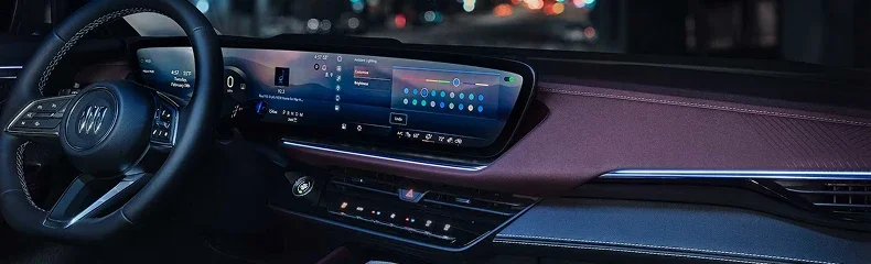 Buick dashboard at night showing the wide curved display and ambient lighting settings
