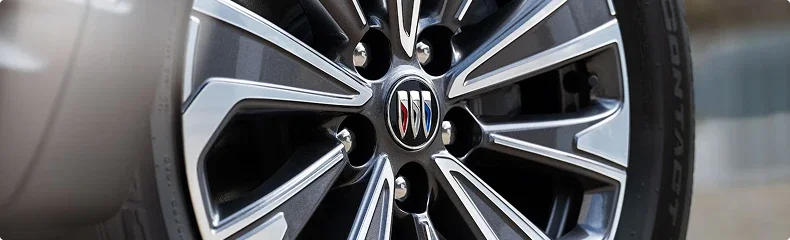 Close-up of a machined Buick alloy wheel with the tri-shield center cap